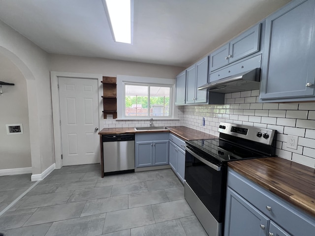 422 Wilderness Rd, Middlesboro, KY 40965 - kitchen with wood counters, appliances with stainless steel finishes, arched walkways, tasteful backsplash, and open shelves