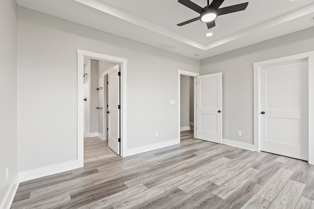 unfurnished bedroom with baseboards and light wood-type flooring