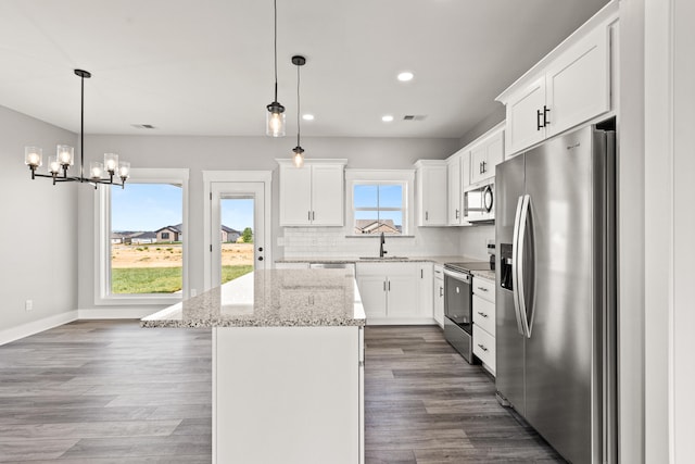 kitchen with visible vents, a center island, recessed lighting, a chandelier, and stainless steel appliances