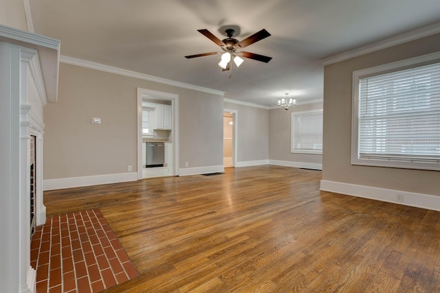 unfurnished living room featuring a chandelier, a ceiling fan, wood finished floors, a tiled fireplace, and ornamental molding