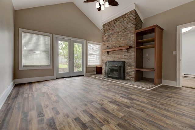 unfurnished living room featuring ceiling fan, wood finished floors, baseboard heating, baseboards, and high vaulted ceiling