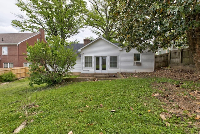 rear view of property with entry steps, a chimney, french doors, and cooling unit