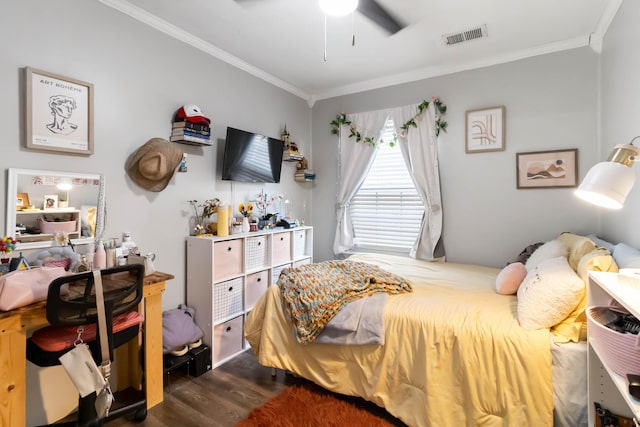 bedroom with crown molding, dark wood finished floors, and ceiling fan