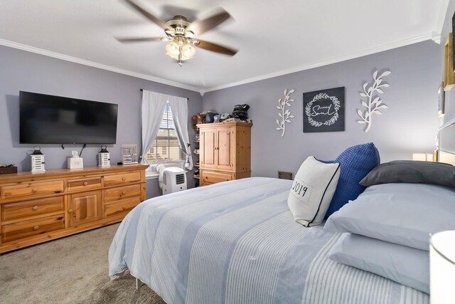 carpeted bedroom featuring ornamental molding and a ceiling fan