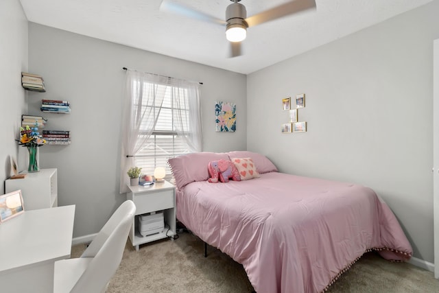 carpeted bedroom with ceiling fan and baseboards