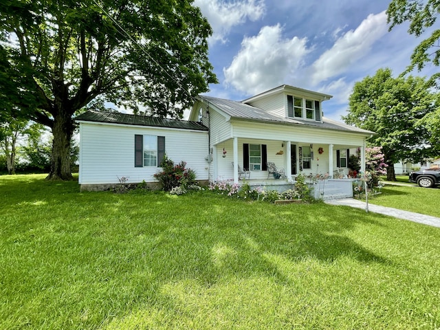 130 Branch Rd, Monticello, KY 42633 - view of front facade with covered porch, metal roof, and a front lawn