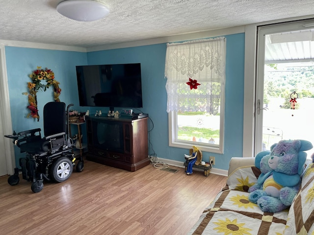 130 Branch Rd, Monticello, KY 42633 - living area featuring a textured ceiling, visible vents, plenty of natural light, and wood finished floors