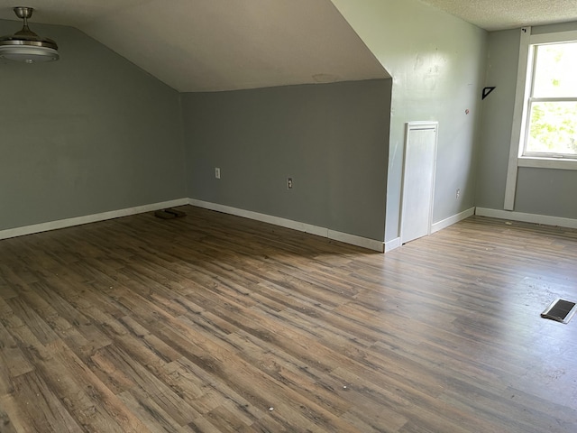 130 Branch Rd, Monticello, KY 42633 - bonus room featuring visible vents, lofted ceiling, wood finished floors, baseboards, and a textured ceiling