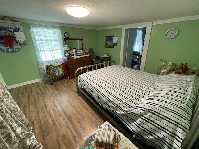130 Branch Rd, Monticello, KY 42633 - bedroom with baseboards, a textured ceiling, crown molding, and wood finished floors
