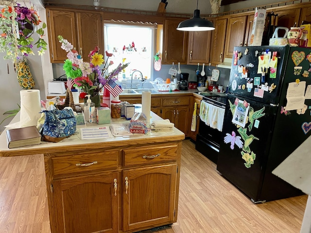 130 Branch Rd, Monticello, KY 42633 - kitchen featuring brown cabinets, a sink, light countertops, light wood-type flooring, and black appliances