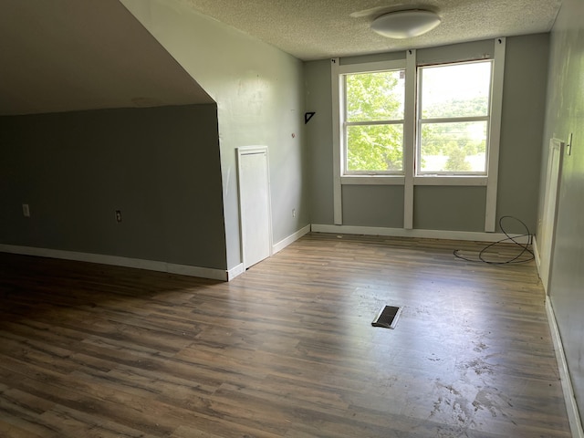 130 Branch Rd, Monticello, KY 42633 - bonus room featuring visible vents, baseboards, a textured ceiling, and wood finished floors