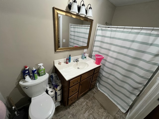 bathroom featuring toilet, a shower with shower curtain, and vanity