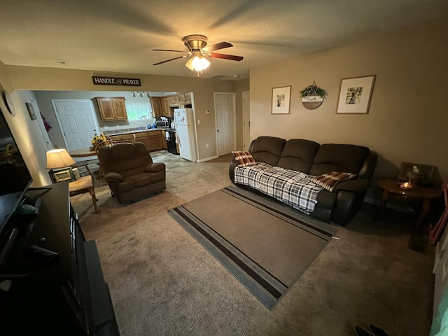 living area featuring ceiling fan and light carpet