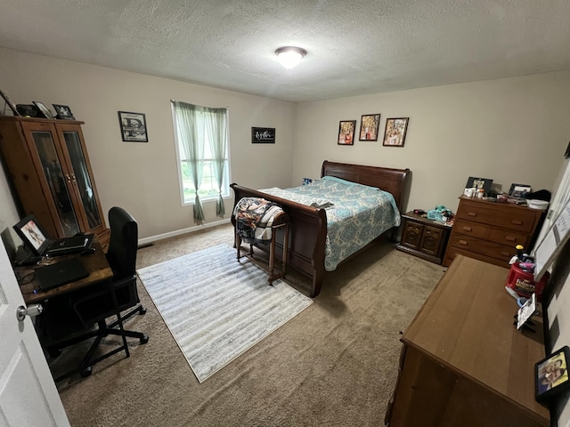 bedroom with baseboards, light carpet, and a textured ceiling