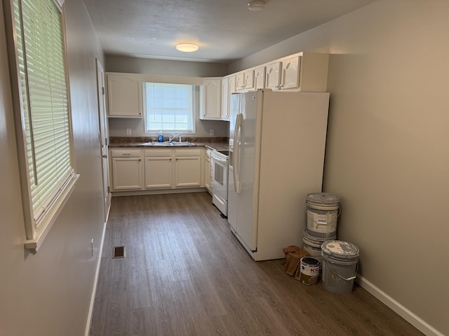 kitchen featuring a sink, white appliances, dark wood-style floors, and white cabinetry
