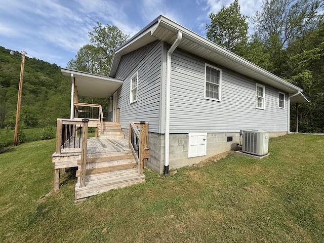view of home's exterior featuring central AC unit, a yard, a deck, and crawl space