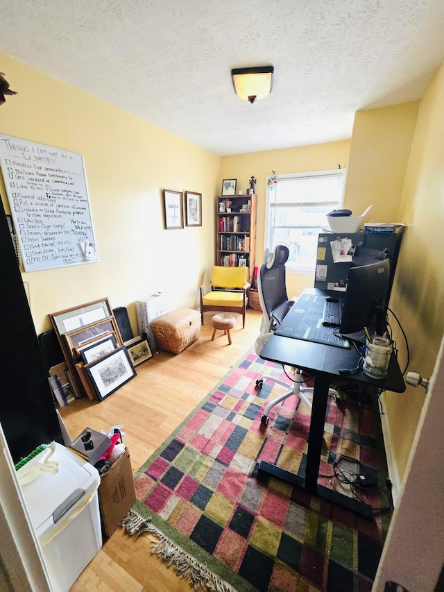 office space with a textured ceiling and wood finished floors