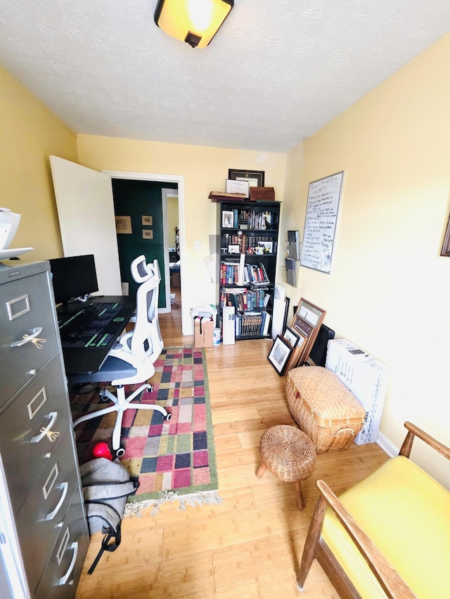 home office featuring a textured ceiling and wood finished floors
