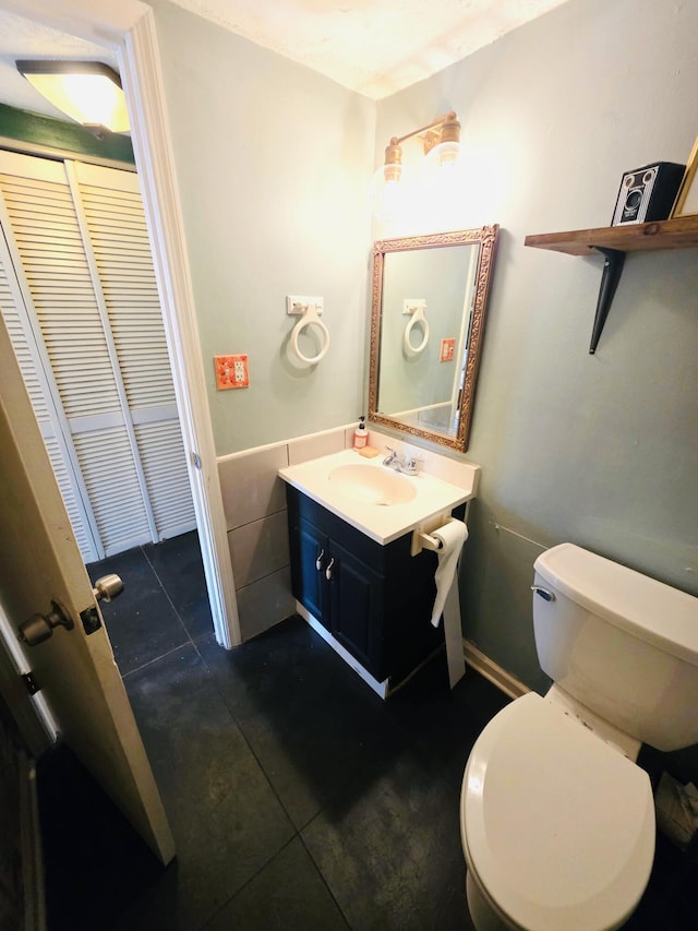 bathroom featuring toilet and vanity