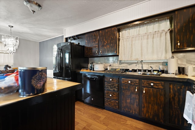 88 Plum St, Stanton, KY 40380 - kitchen with black appliances, light wood finished floors, a sink, dark brown cabinetry, and a chandelier