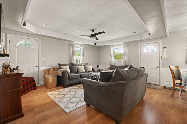 88 Plum St, Stanton, KY 40380 - living room with a tray ceiling, a ceiling fan, light wood finished floors, and a textured ceiling