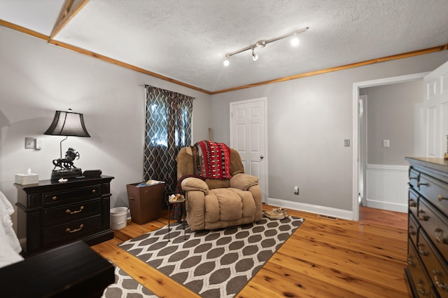 88 Plum St, Stanton, KY 40380 - living area with light wood-type flooring, a textured ceiling, and ornamental molding