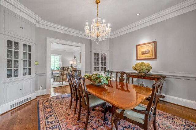 101 Idle Hour Dr Unit 1, Lexington, KY 40502 - dining area with crown molding, a chandelier, wood finished floors, a wainscoted wall, and a decorative wall