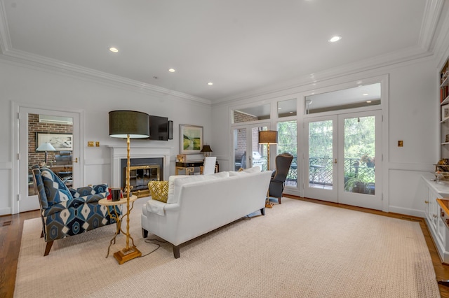 101 Idle Hour Dr Unit 1, Lexington, KY 40502 - living area with crown molding, a glass covered fireplace, wood finished floors, recessed lighting, and a decorative wall