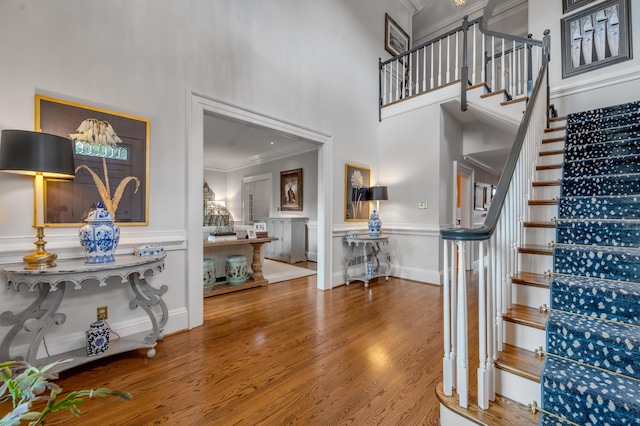 101 Idle Hour Dr Unit 1, Lexington, KY 40502 - staircase featuring ornamental molding, a high ceiling, wood finished floors, a decorative wall, and a wainscoted wall