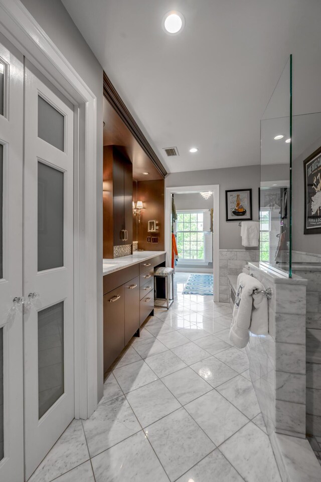 101 Idle Hour Dr Unit 1, Lexington, KY 40502 - full bath featuring vanity, recessed lighting, marble look tiles, and a wainscoted wall