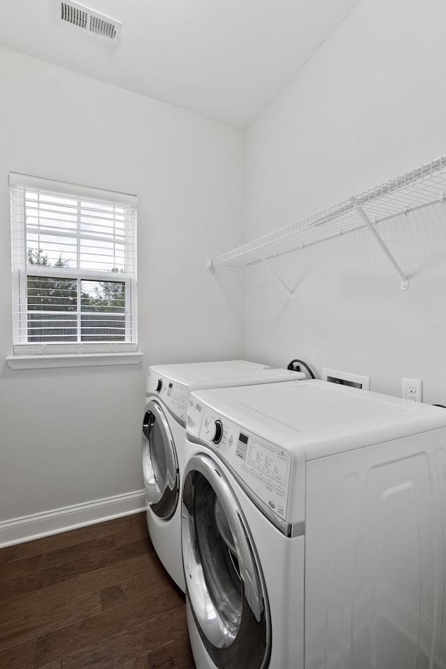laundry room featuring separate washer and dryer, baseboards, and dark wood-style flooring