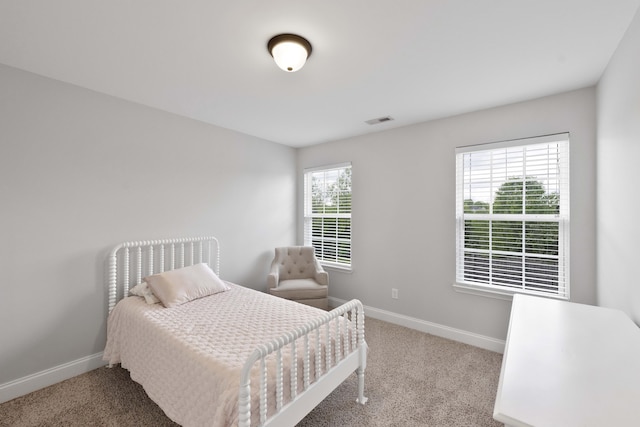 carpeted bedroom featuring baseboards