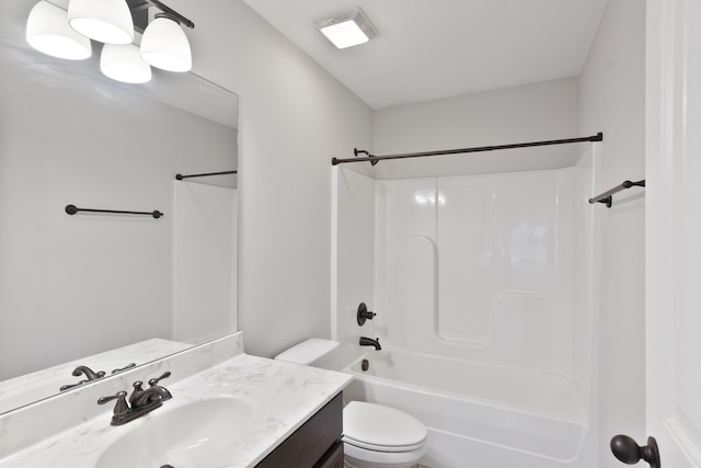 bathroom with toilet, vanity, and  shower combination
