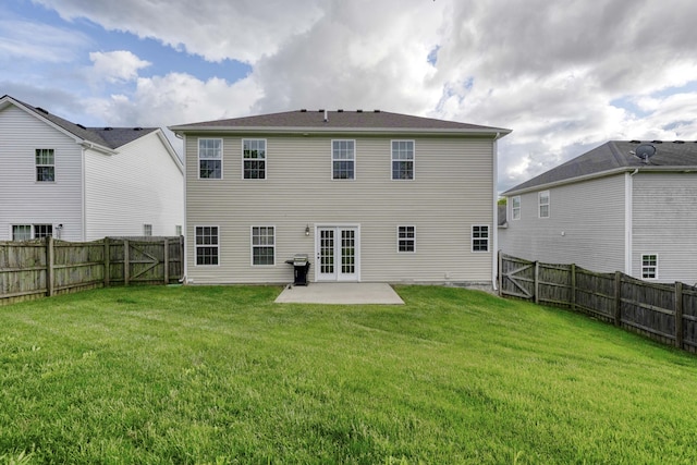 back of property with a patio area and french doors