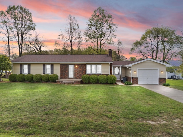 single story home featuring a chimney, brick siding, a garage, a front yard, and driveway