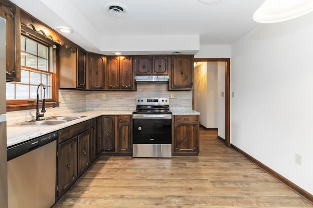 3716 Hickory Hill Dr, Somerset, KY 42503 - kitchen with a sink, appliances with stainless steel finishes, under cabinet range hood, light countertops, and light wood-style floors