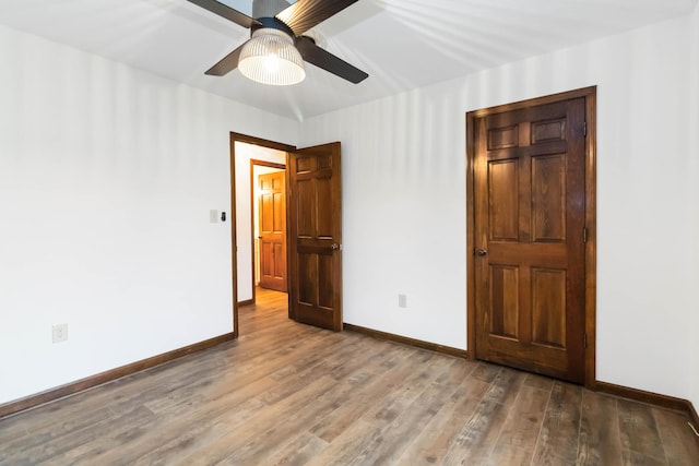 3716 Hickory Hill Dr, Somerset, KY 42503 - unfurnished bedroom with baseboards, a ceiling fan, and wood finished floors