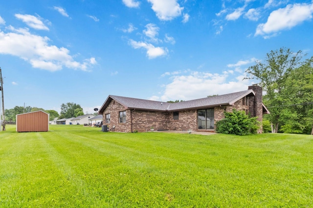 3716 Hickory Hill Dr, Somerset, KY 42503 - rear view of house with a lawn, an outdoor structure, brick siding, and a storage shed