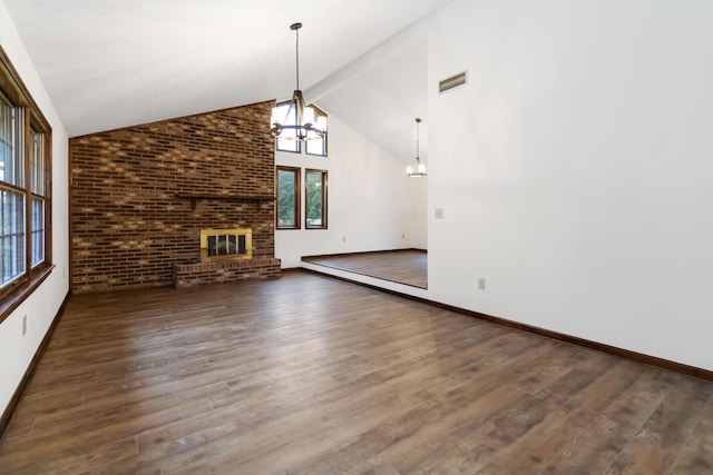 3716 Hickory Hill Dr, Somerset, KY 42503 - unfurnished living room featuring an inviting chandelier, a brick fireplace, visible vents, and wood finished floors