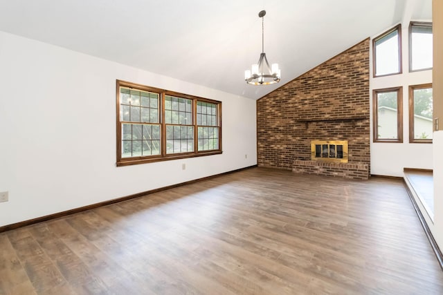 3716 Hickory Hill Dr, Somerset, KY 42503 - unfurnished living room with a notable chandelier, high vaulted ceiling, plenty of natural light, and wood finished floors