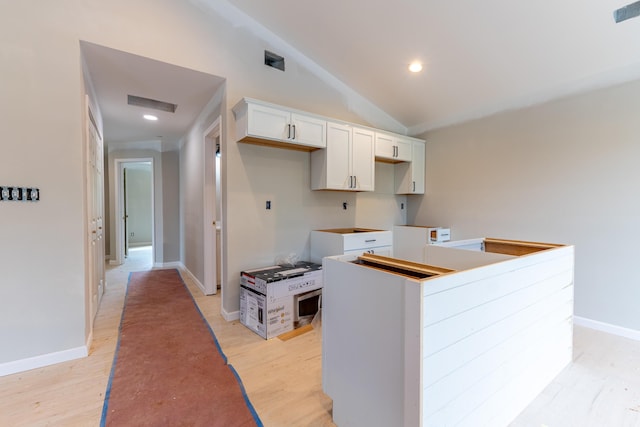 301 Meece St, Somerset, KY 42501 - kitchen featuring light wood finished floors, white cabinetry, lofted ceiling, a kitchen island, and recessed lighting