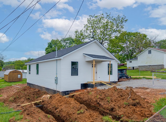 301 Meece St, Somerset, KY 42501 - rear view of house featuring an outbuilding, fence, a storage unit, and a shingled roof