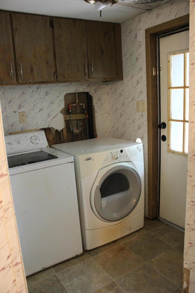 washroom with cabinet space and washing machine and dryer