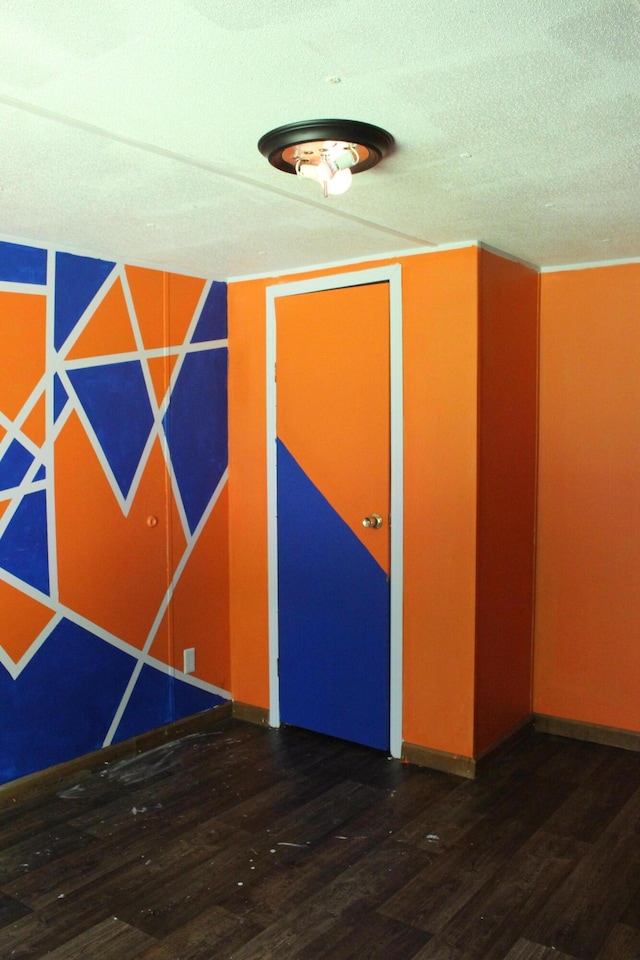 spare room with wood finished floors and baseboards