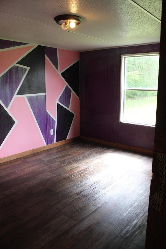 spare room with wood finished floors