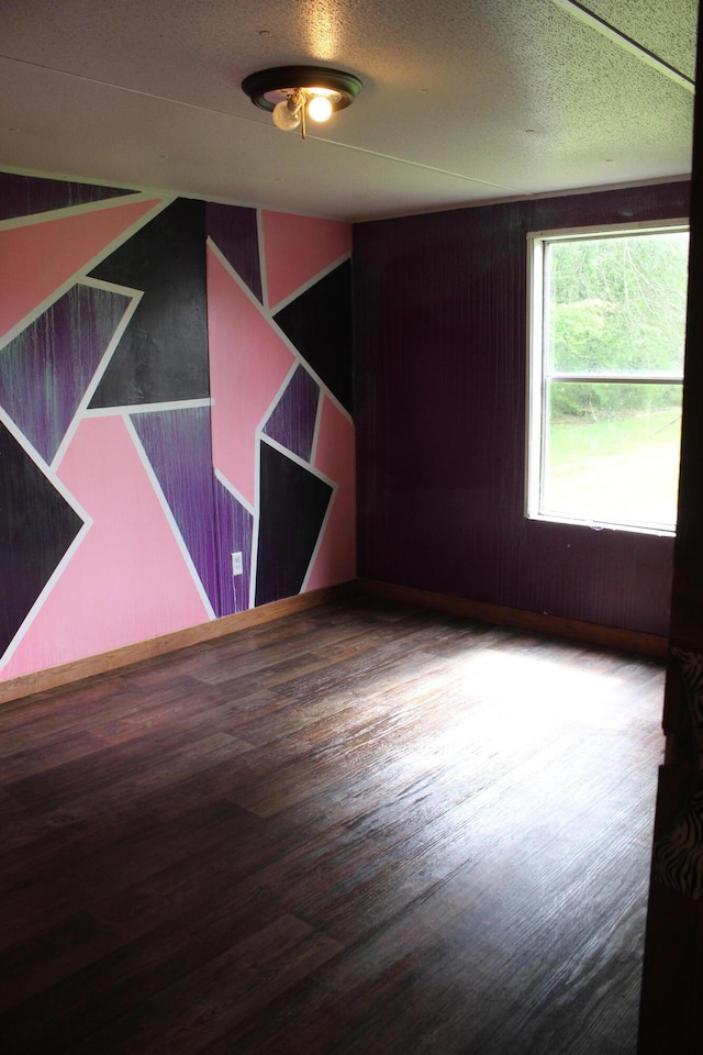unfurnished room with wood finished floors