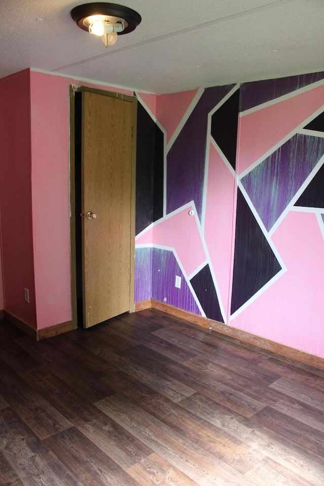 interior space featuring baseboards and wood finished floors