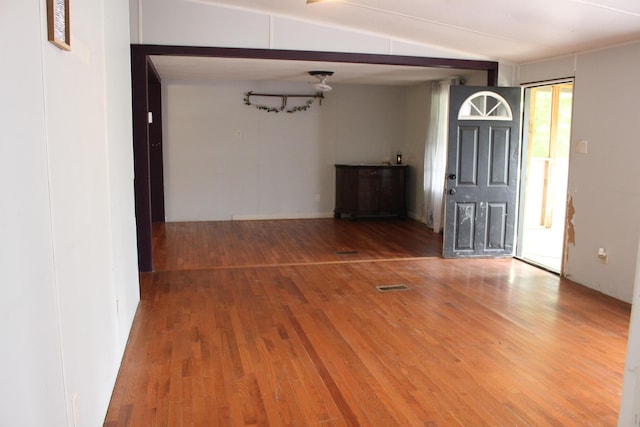 entryway featuring visible vents, beam ceiling, and wood finished floors