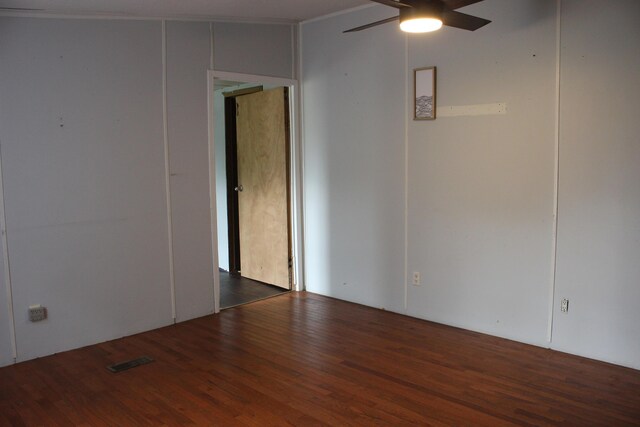 unfurnished room featuring a ceiling fan, visible vents, and wood finished floors