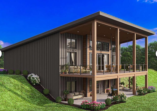 back of property featuring a patio, board and batten siding, a balcony, and a yard